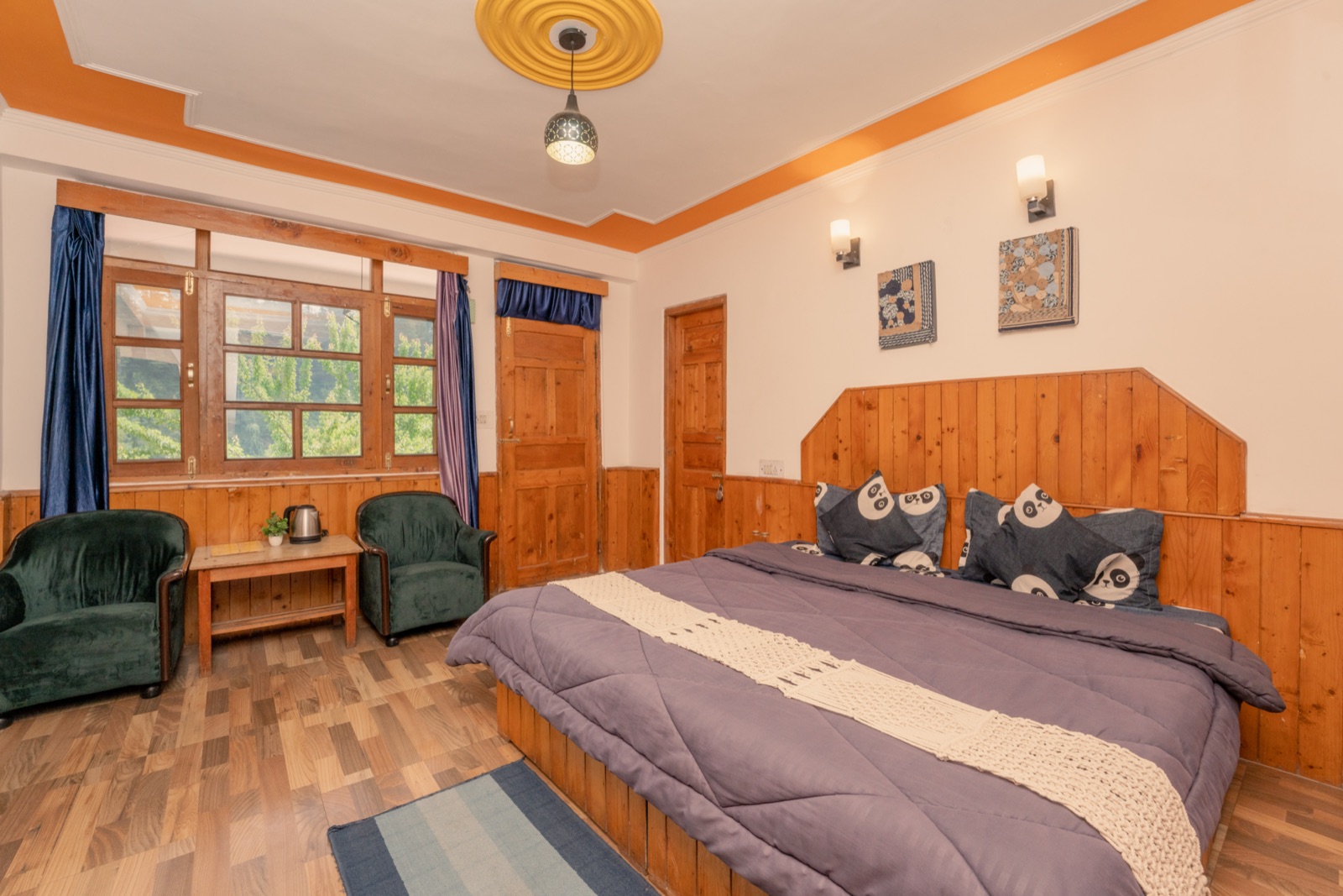 Room with the balcony door open to a mountain and forest view