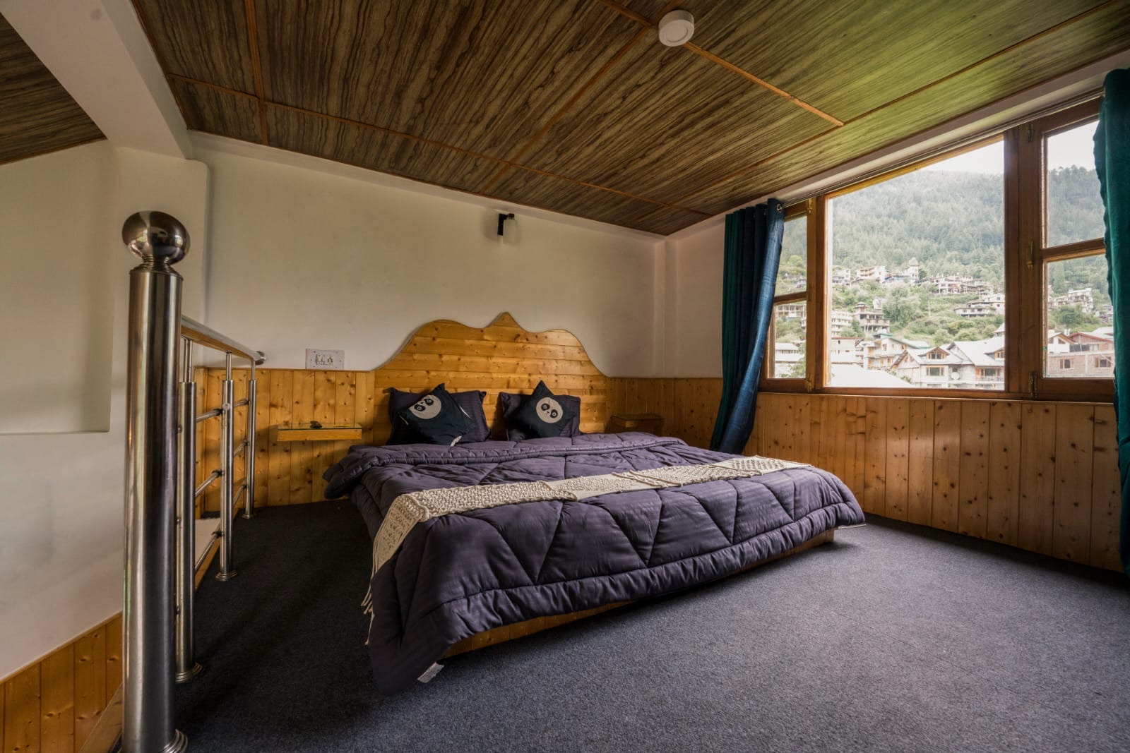 Room window looking out over Old Manali rooftops and hillside
