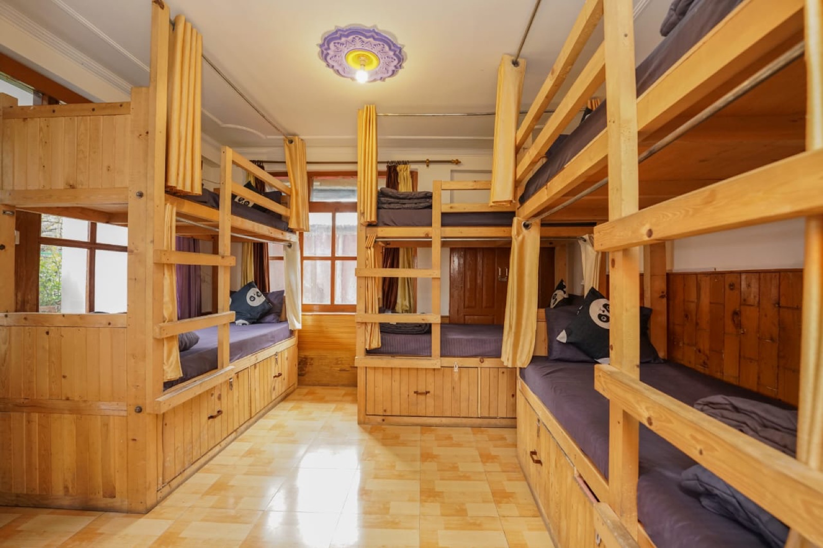 Wide view of the 6-bed dorm, row of bunks along both walls