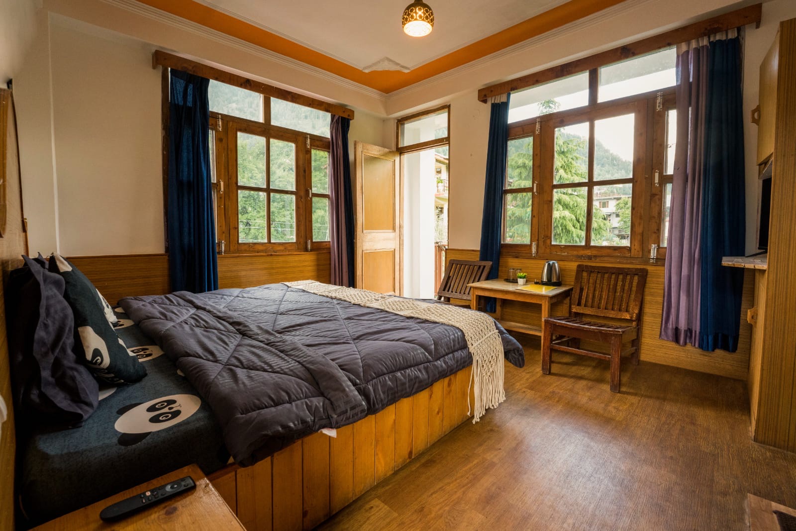 Private double room, bed made, daylight through the windows
