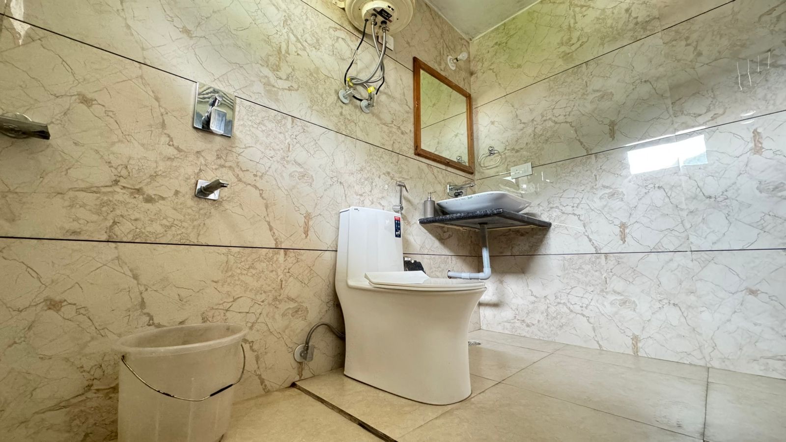 Attached bathroom with toilet and health faucet